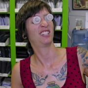 Woman with short dark hair and tattoos goofing around